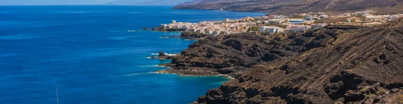 Dramatic black volcanic cliffs meeting the Atlantic Ocean in the Canary Islands